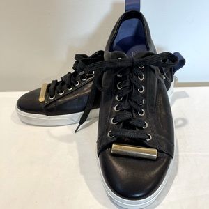 Stuart Weitzman black leather sneaker with metal accents